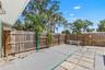 Additional fenced patio space offers even more room for outdoor dining, grilling, or creating a separate sitting area.