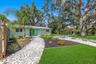 Wide view highlights the home’s spacious .19-acre lot, mature shade trees, tropical landscaping, and generous outdoor space.