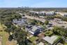 An aerial view shows the home and surrounding neighborhood of College Park with Orlando in the background.