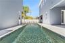 A lengthwise pool view shows the surrounding paved deck and the relationship to the home.