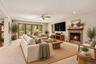 Virtually staged to showcase the living room’s contemporary comfort and generous proportions, highlighting the beautiful fireplace and expansive mahog