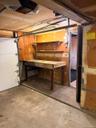 garage with door to inside. separate space for work bench
