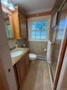 Full bath on main level, walk-in shower,  enclosed with glass doors