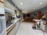 Entry from the back door to the kitchen with gas stove