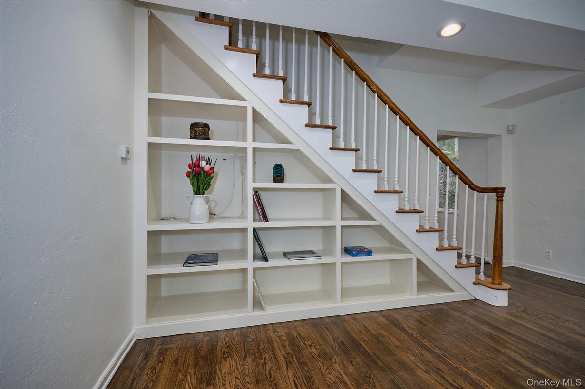 Stairway with wood finished floors and recessed lighting