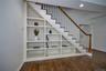 Stairway with wood finished floors and recessed lighting