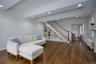Living room with recessed lighting, radiator heating unit, dark wood finished floors, and stairs