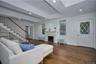 Living area with dark wood-type flooring, radiator, a brick fireplace, and recessed lighting