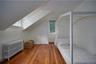 Bonus room featuring radiator, hardwood / wood-style flooring, plenty of natural light, and lofted ceiling