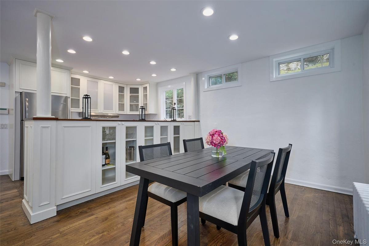 Dining room featuring recessed lighting, dark wood finished floors, and radiator