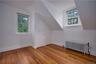 Bonus room featuring radiator heating unit, hardwood / wood-style flooring, and vaulted ceiling