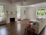 Living area featuring dark wood finished floors, radiator, and a fireplace