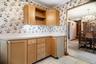 The kitchen has additional wood cabinets with formica counters for extra storage and prep space.
