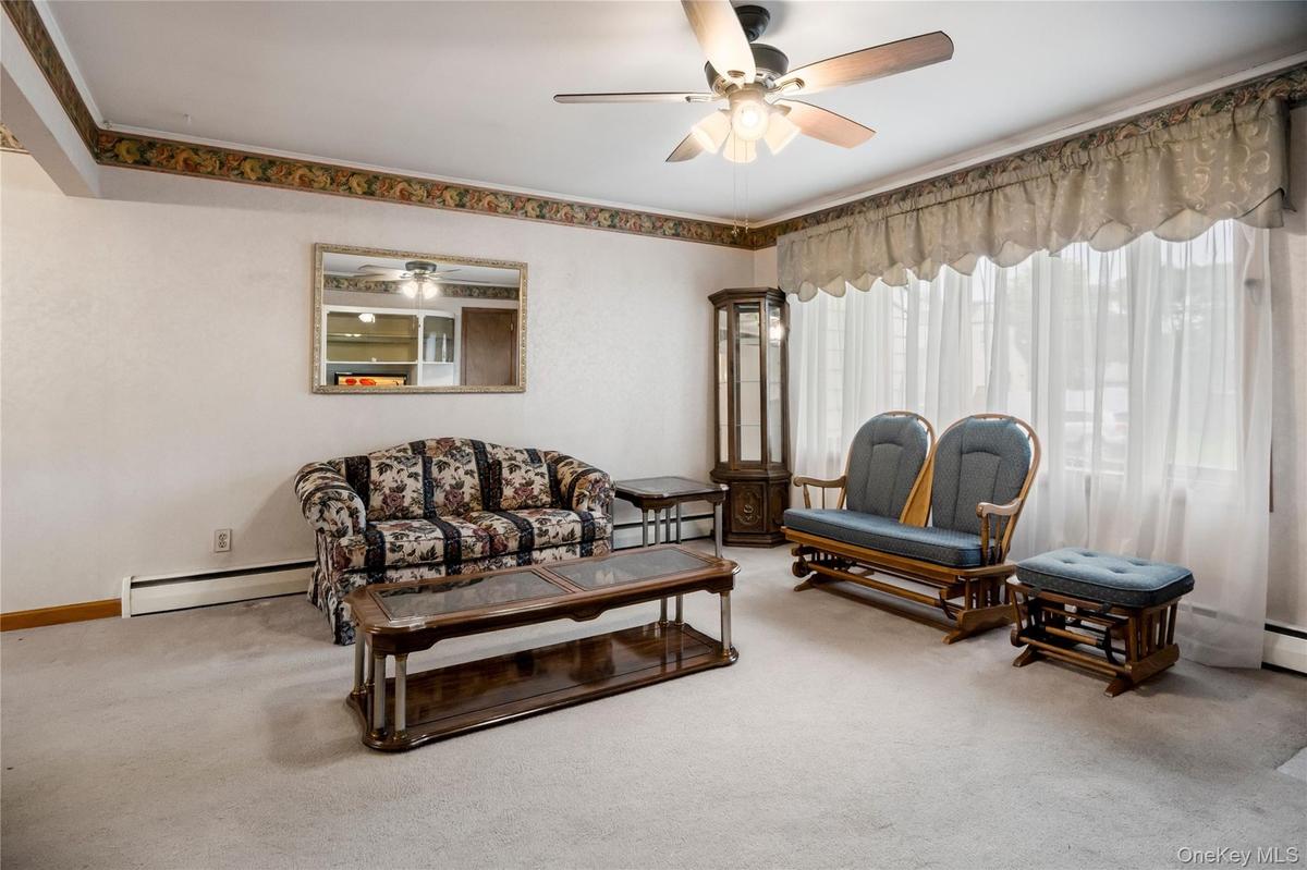 The living room is filled with lots of natural light during the day from the large bow window.