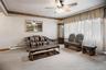 The living room is filled with lots of natural light during the day from the large bow window.