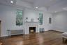 Unfurnished living room featuring radiator, dark wood finished floors, recessed lighting, and a tray ceiling