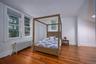 Bedroom featuring radiator heating unit and hardwood / wood-style floors