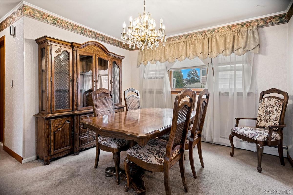 Both the dining room & living room are carpeted, but hardwood floors exist under the carpeting throughout the entire main floor.