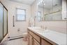 The hallway bath features a large vanity & a shower/tub.