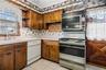 There is ceramic tile flooring and an outside entrance door, opening to a small porch and the side yard.