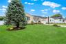 ...and the front of the home has vinyl shake siding (approx. 20 yrs) and mature landscaping with in-ground sprinklers.