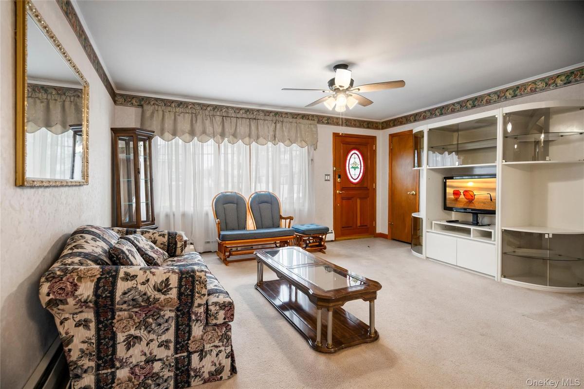 Looking from the dining room towards the living room, front door & coat closet.