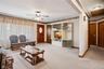 Off the living room & dining room is the hallway leading to the bathroom, bedrooms & the basement stairs.