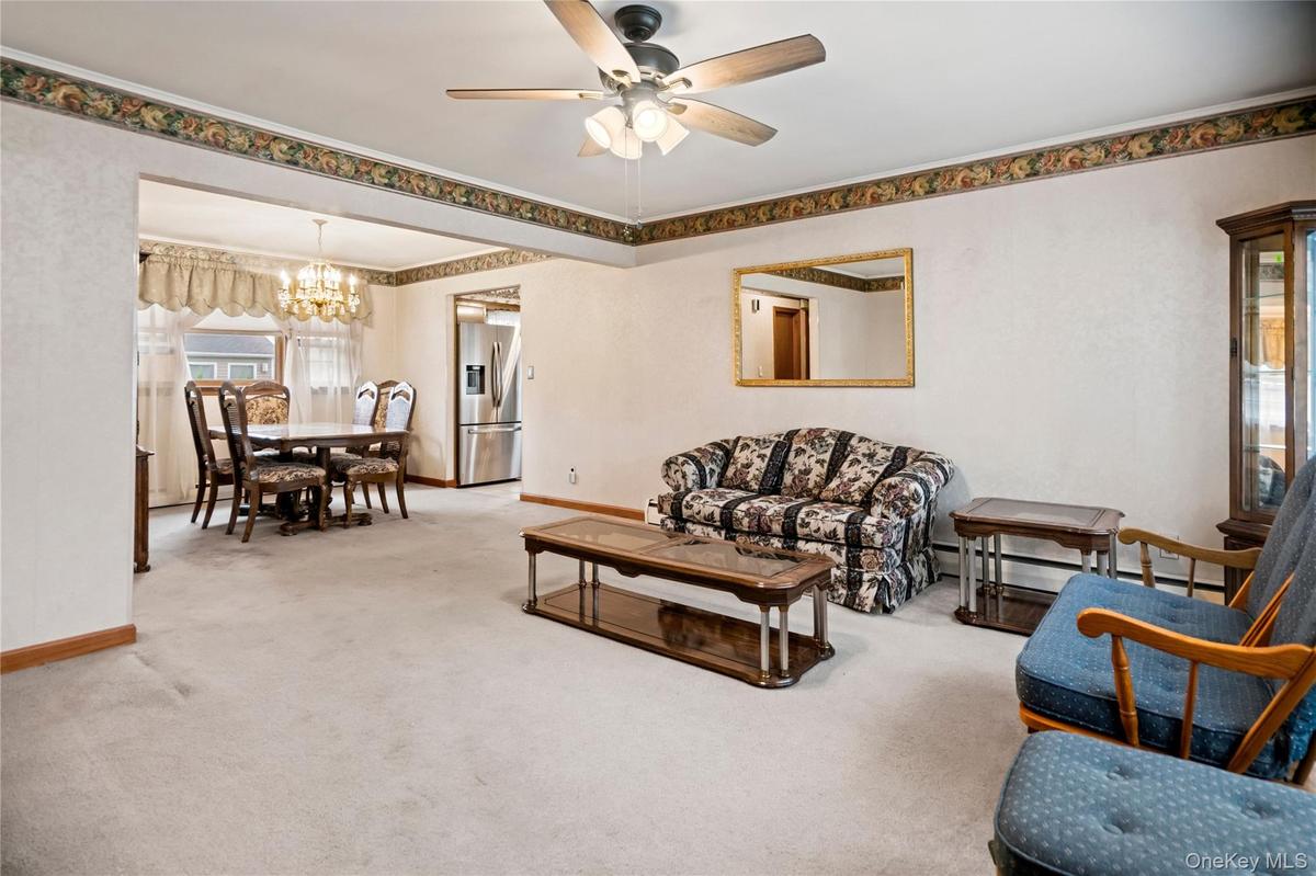 Looking from the front entryway, through the living room and towards the dining room & kitchen.