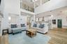 High ceilings in this welcoming family room filled with natural light