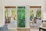 All windows—including this quad slider—are hurricane impact, offering seamless indoor-outdoor living, added peace of mind, energy efficiency, and nois
