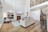 Featuring shiplap, built in shelving & a gas fireplace, the family room is open to the kitchen & breakfast area