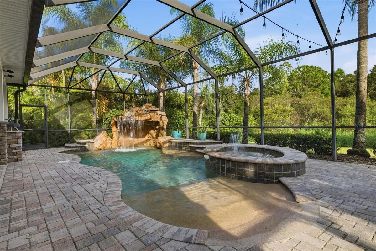 Gorgeous pool with waterfall, spa, fountain & beach entry