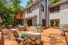 A wraparound deck extends seamlessly from the main-level living space, creating an inviting outdoor extension where thoughtful design and nature beaut
