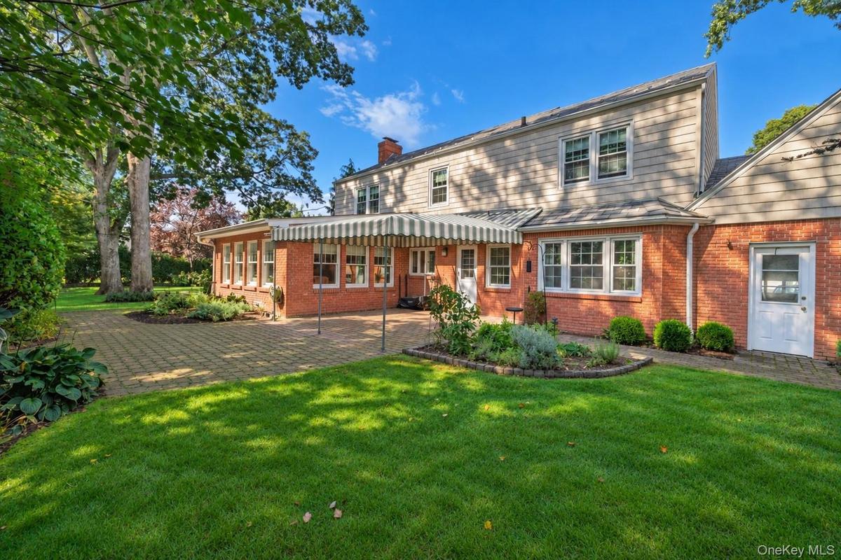 Rear View Of This Brick Styled Cape Cod Home