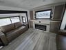 RV: Lounge area with pop-up 52 inch TV and electronic fireplace underneath fireplace. 2 fold down sofa beds.