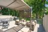 Expansive outdoor deck featuring a fixed pergola, privacy screening, and wood-finish decking