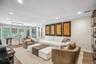 Open-concept living space with recessed lighting, crown molding, and wood-finish flooring