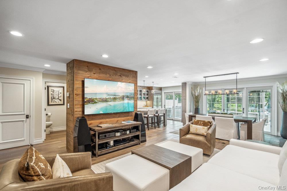 Open-concept living space featuring wood-finish flooring and recessed lighting