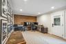 Shiplap accent wall, recessed lighting, crown molding, white trim, and a paneled door with a glass insert
