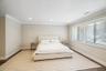 Recessed ceiling lighting, crown molding, wide plank wood-finish flooring, and large windows with blinds