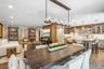 Wood-finish flooring throughout, with recessed lighting and a wood-beamed ceiling