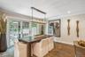 Wood-finish flooring, recessed lighting, and a linear pendant light fixture