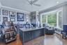 Oak hardwood flooring, recessed lighting, ceiling fan, crown molding, and a bay window