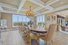 Coffer-style ceiling with recessed lighting, large picture windows, and a chandelier