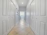 LARGE WALK-IN CLOSET ON THE LEFT WITH SOLAR TUBE, AND ON THE RIGHT MORE CLOSET SPACE. THE 2ND SET OF DOUBLE DOORS ON THE RIGHT HAS MORE STORAGE AND 2N
