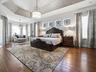 PRIMARY BEDROOM - WOW! HARDWOOD FLOORING, CUSTOM DRAPES, CUSTOM FIXTURES - A SPECTACULAR, SPACIOUS ROOM!