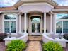 INVITING ENTRANCE WITH PAVERED WALKWAY, FRONT PORCH, AND LEADED GLASS FRONT DOORS!