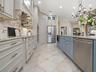 NEW CABINETRY, GRANITE COUNTERTOPS, STAINLESS APPLIANCES WITH 5 BURNER INDUCTION COOKTOP, HOOD, AND MICROWAVE DRAWER, BOSCH DISHWASHER, POT DRAWERS, L