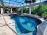 BEAUTIFUL TRAVERTINE DECKING AND TRAVERTINE COLUMNS WITH BRICK ACCENTS.