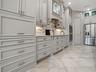 THE APPLIANCE GARAGE CLOSED IN THIS PHOTO, LOVELY TILED BACKSPLASH AND MANY LIGHTING OPTIONS.